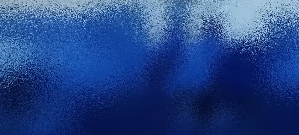 Abstract textured glass surface with blue gradient background.