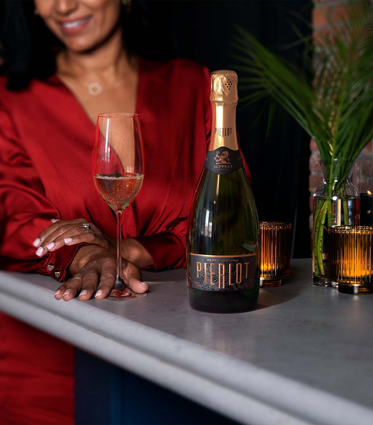 Lifestyle wine photography by Outshinery showing consumer engagement with bottle — realistic lighting and premium brand presentation.