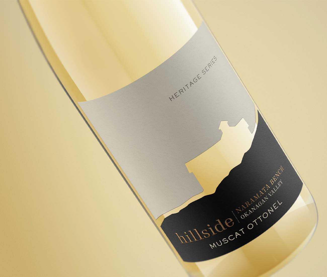 Close-up angled shot of a Hillside Heritage Series Muscat Ottonel bottle with minimalist silver and black label design.