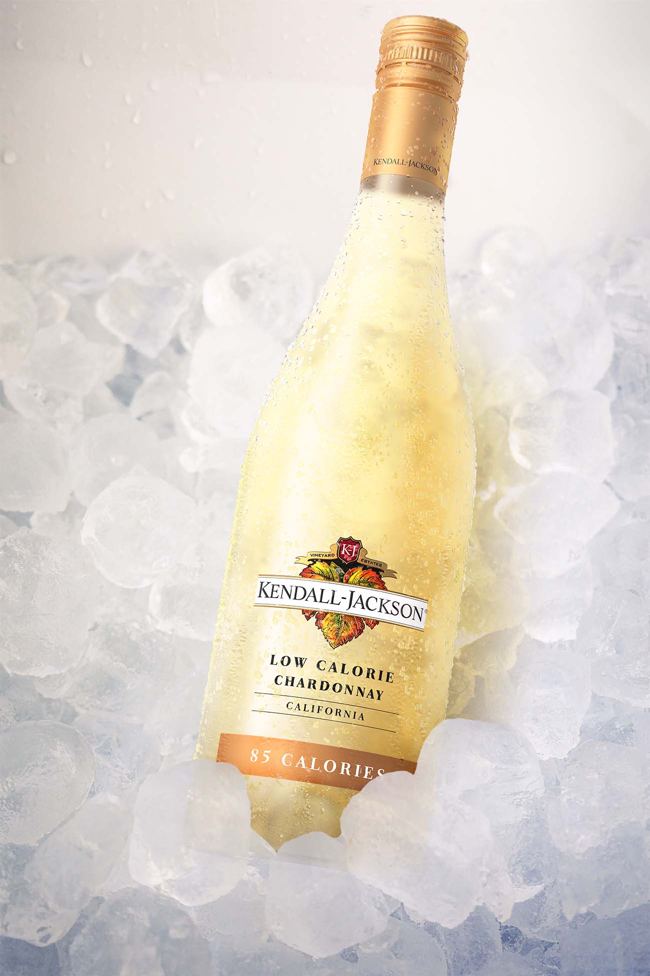 Kendall-Jackson Low Calorie Chardonnay bottle resting in a bed of ice, covered in condensation to highlight its chilled, refreshing appeal.