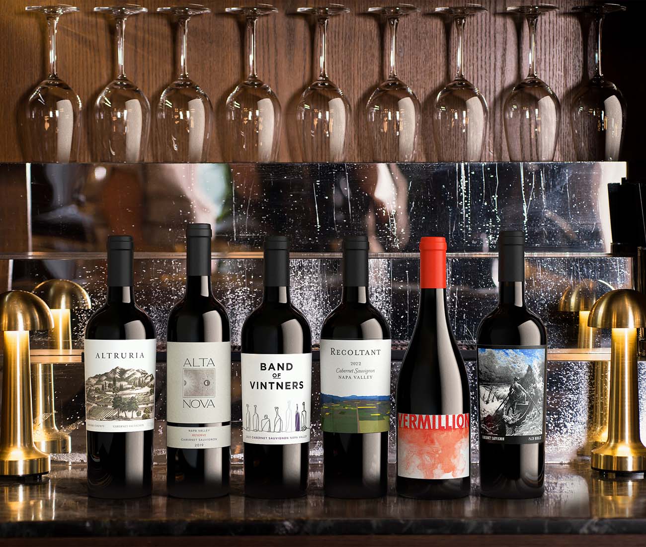 Lifestyle bar shelf display featuring rows of spirits and wine bottles with assorted glassware, illustrating the impact of professional, consistent product images in real-world settings.