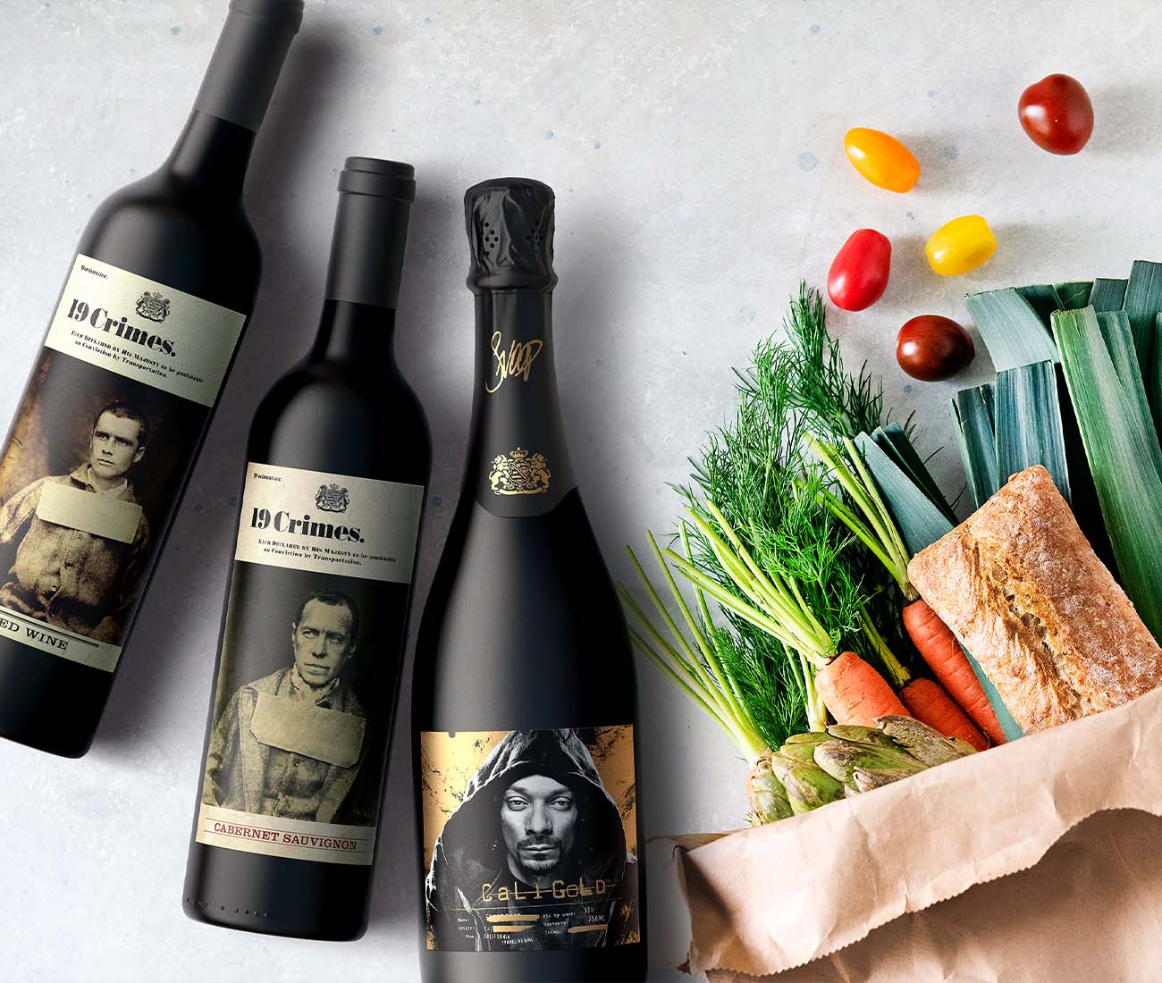 Assortment of iconic Australian wine bottles arranged with fresh ingredients and small dishes in a bright lifestyle flat lay.