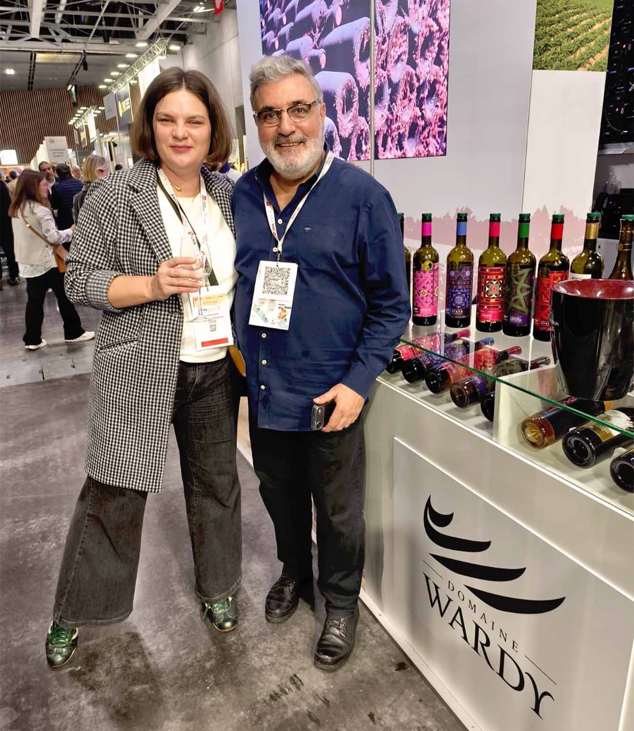 Laurie Millotte of Outshinery with exhibitors at the Domaine Wardi wine booth during Wine Paris trade show