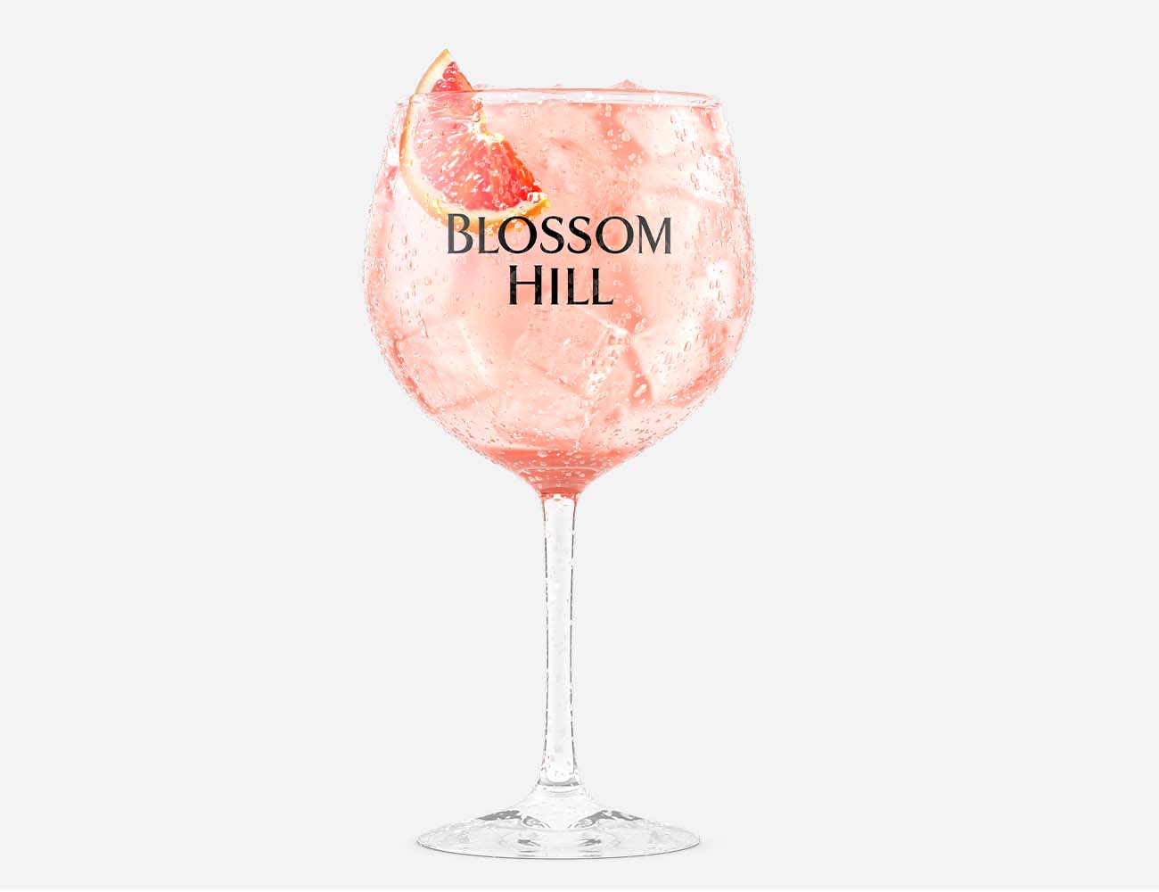 Wine spritzer in a branded glass with blood orange garnish, ice cubes, and condensation droplets
