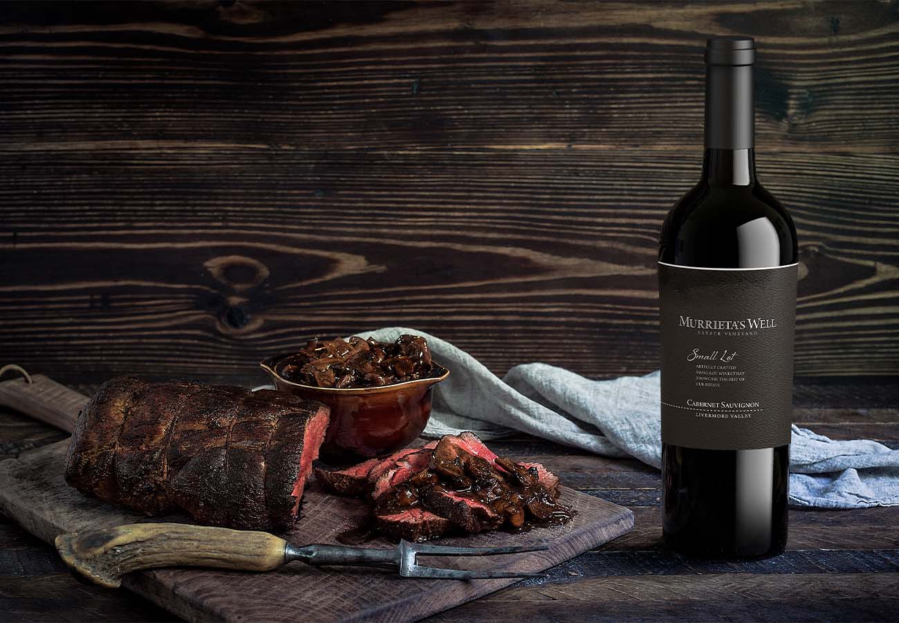 Cabernet Sauvignon wine bottle from Livermore Valley next to a roasted beef steak with mushrooms