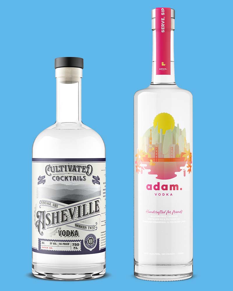 2 bottles of premium vodka shot by Outshinery on a blue background