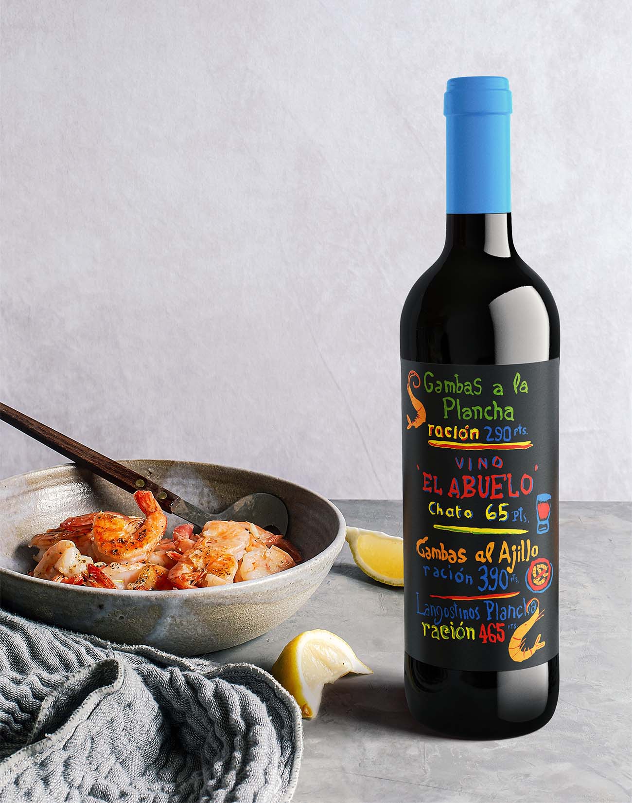 Vino El Abuelo wine bottle in a lifestyle product shot paired with shrimp and lemon, colorful chalkboard-style Spanish label