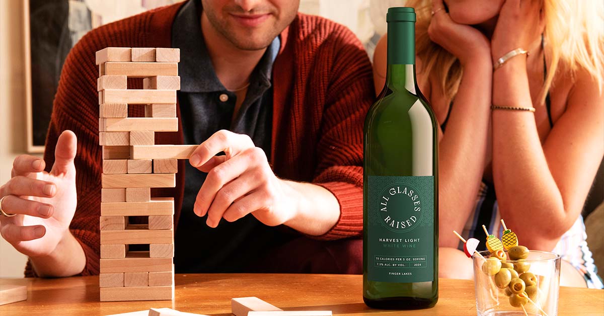 low-alcohol white wine on a table with a game of Jenga. A lifestyle image done by Outshinery.
