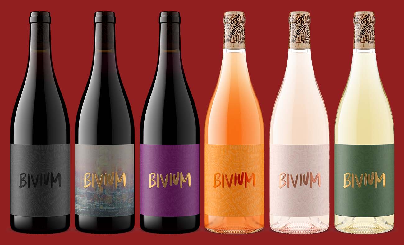 Six Bivium wines in a SKU lineup with reds in dark green Burgundy bottles and rosés and white in flint glass with wax-dipped corks, rendered with consistent angle, lighting, and scale