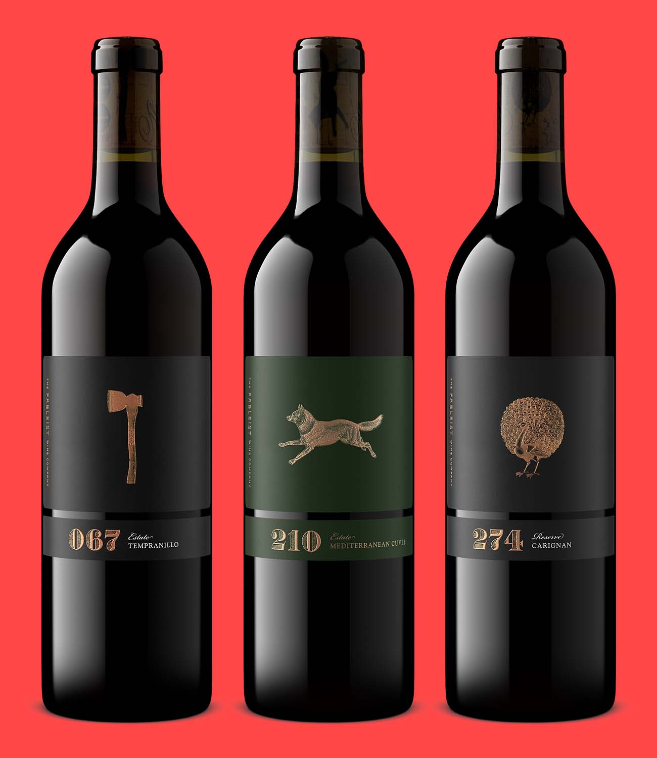 Three Fableist Wine Company red wine bottle shots with gold foil labels, lit identically so reflections and color match across the lineup