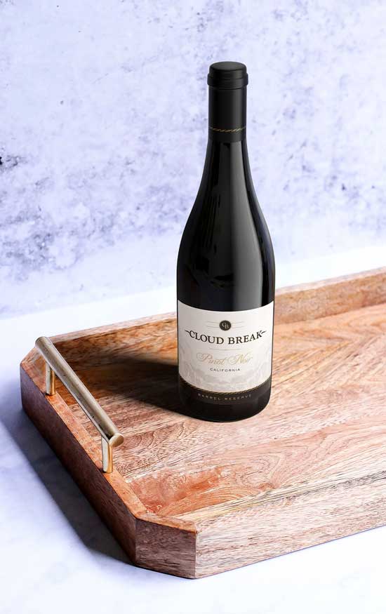 Cloud Break Pinot Noir Barrel Reserve bottle shot on a wooden serving tray against pale marble, by Outshinery