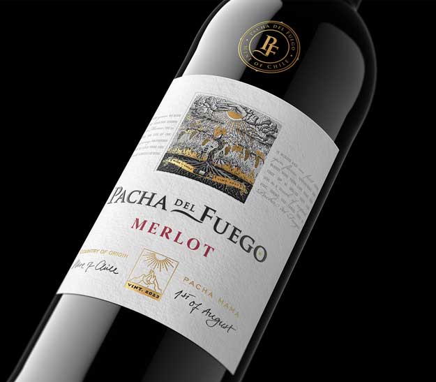 Pacha del Fuego Merlot 2023 bottle close-up, gold foil crest and engraved Chilean label artwork on black, by Outshinery