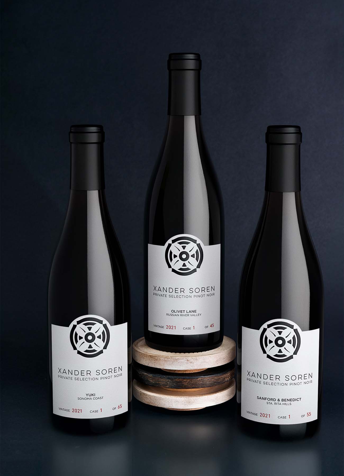 Three bottles of Xander Soren Private Selection Pinot Noir 2021 in a custom dark scene built by Outshinery Studio