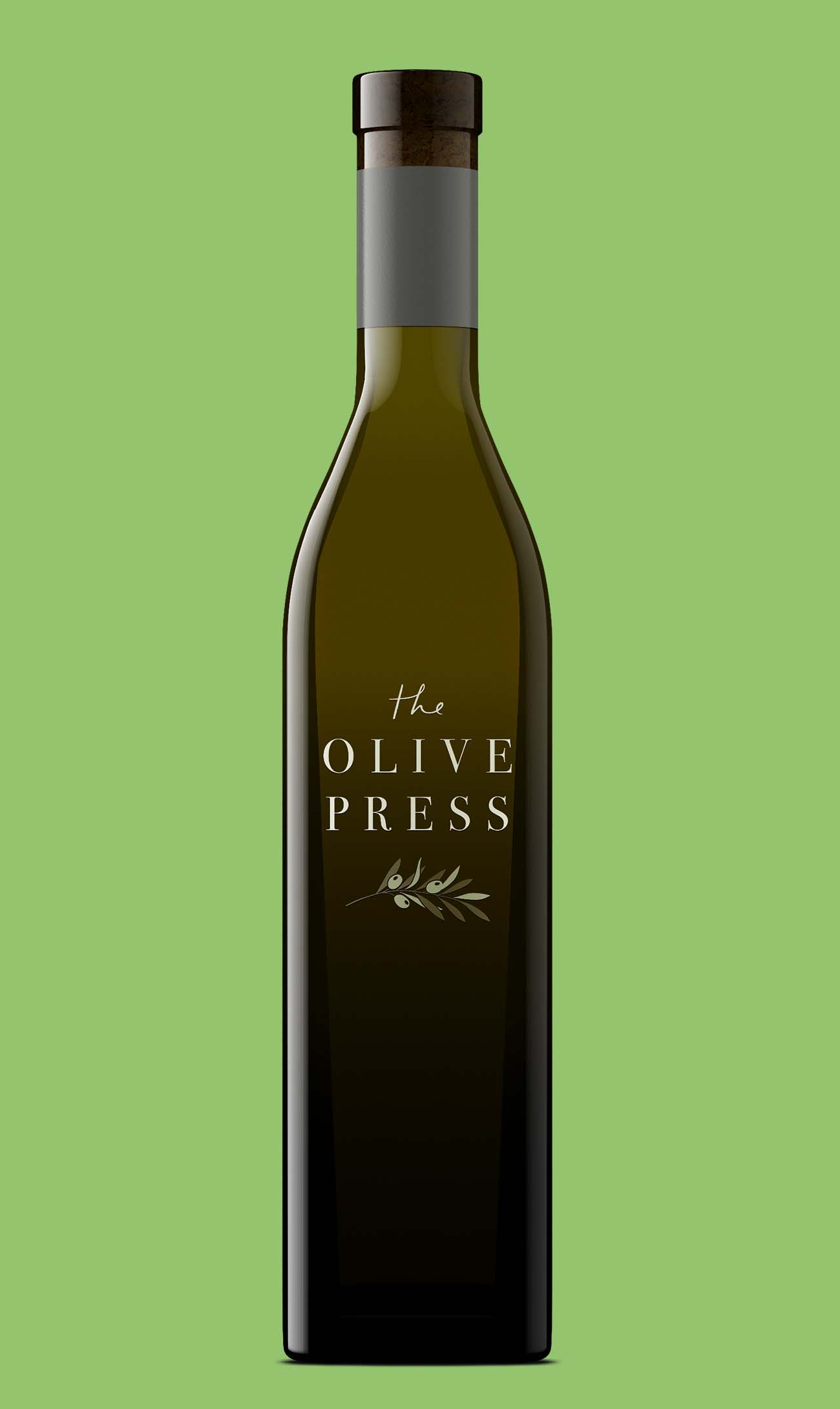 The Olive Press bottle in tall dark olive glass with a cork closure and artwork printed straight onto the glass, no paper label