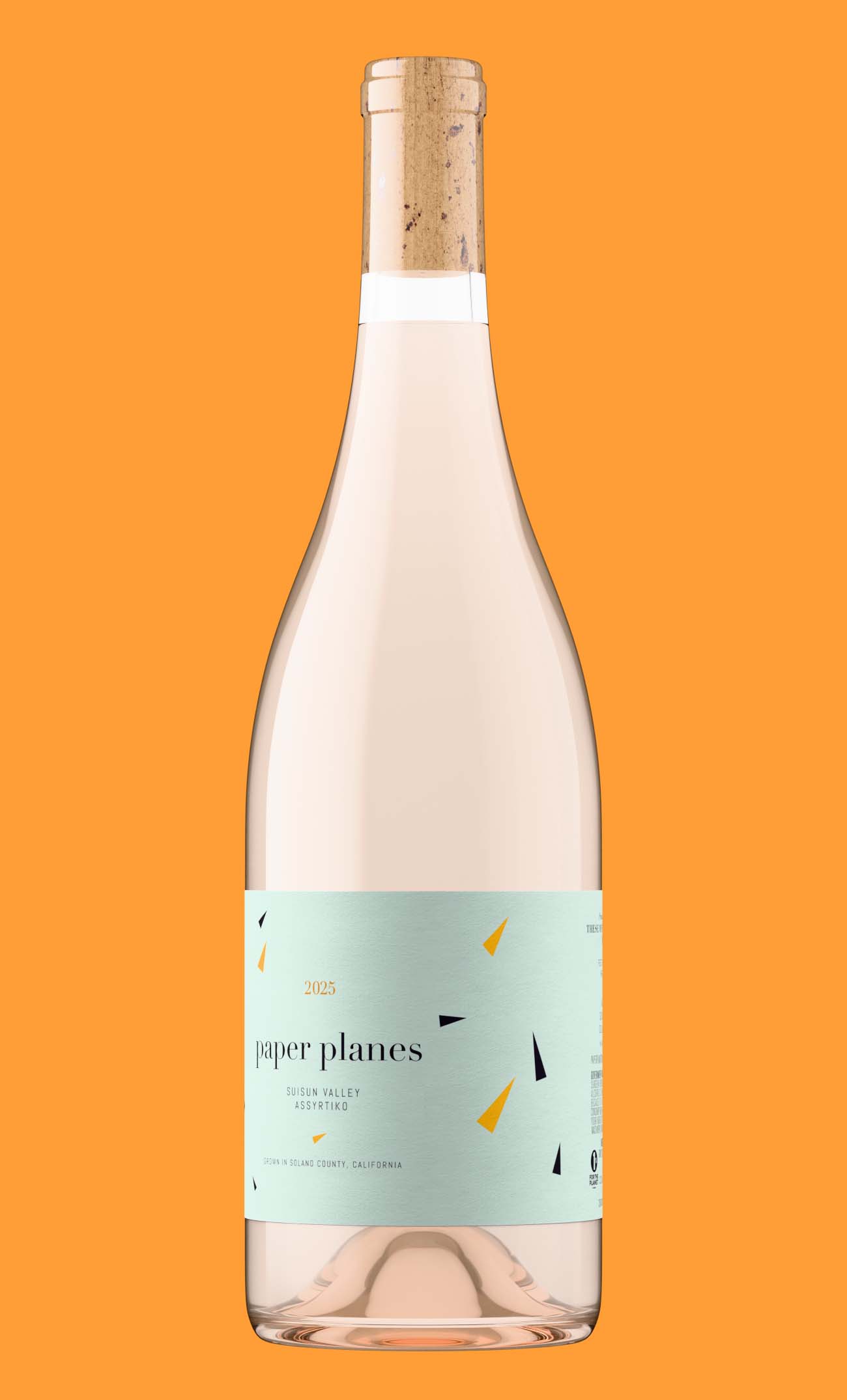 Pale wine in a clear flint bottle with a natural cork and a mint green label, the case where liquid color choice matters most in a bottle shot