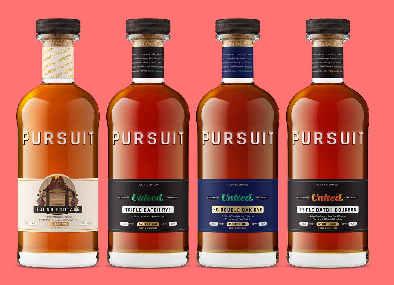 Four Pursuit whiskey bottles with a custom bottle shape, embossed brand lettering, and wood toppers, lined up on a coral background
