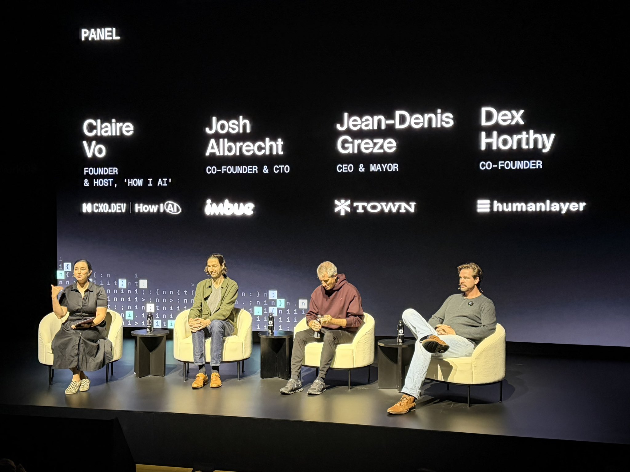 Claire Vo's panel on stage at WorkOS init(), with the panelists' names shown on the stage screen.