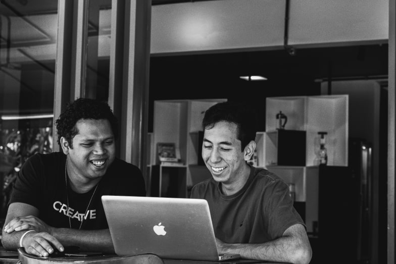 Two entrepreneurs working together at a laptop