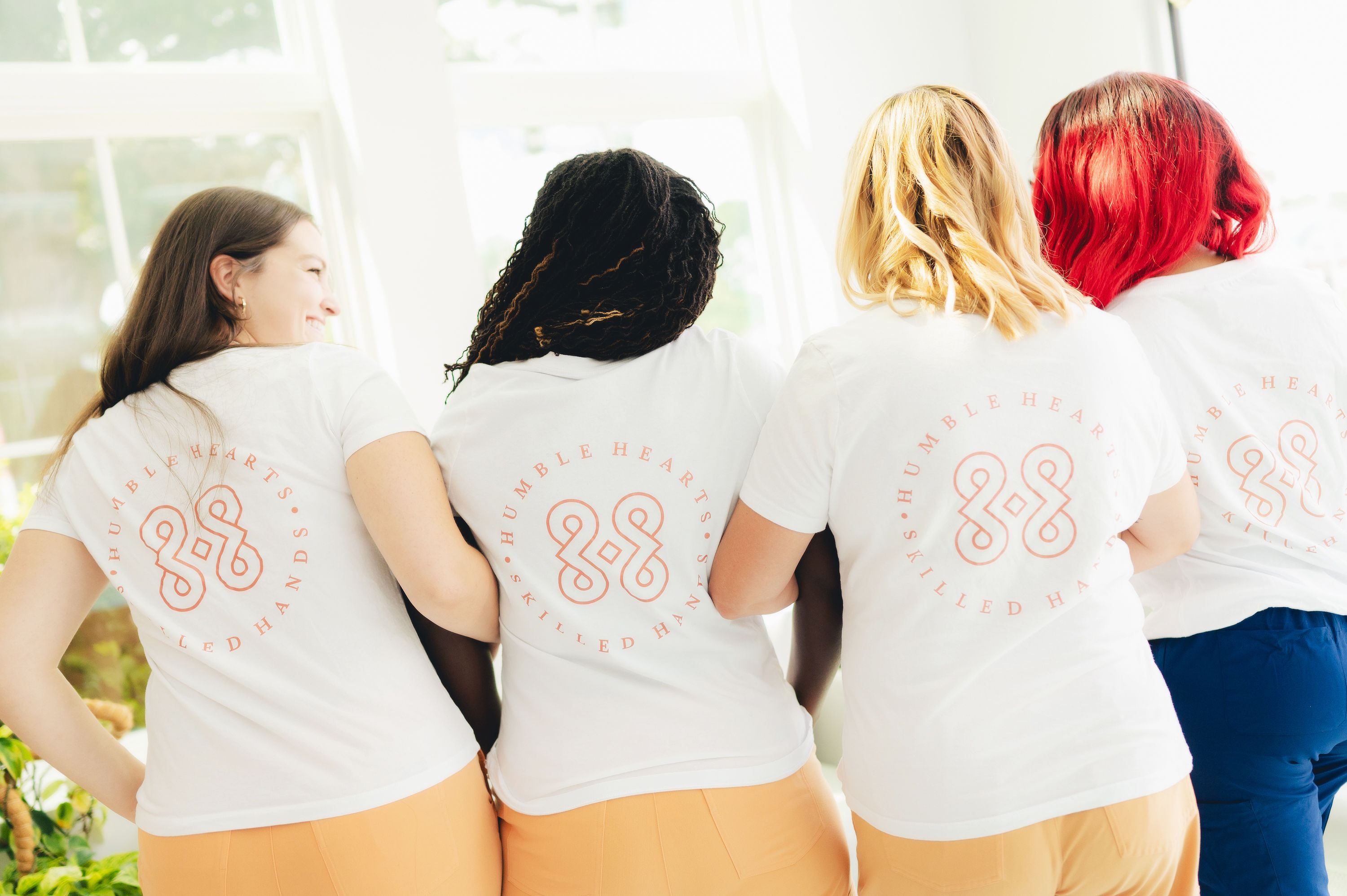 Dentist at Cusp Dental Boutique showing patient a tooth model during consultation for personalized dental care.
