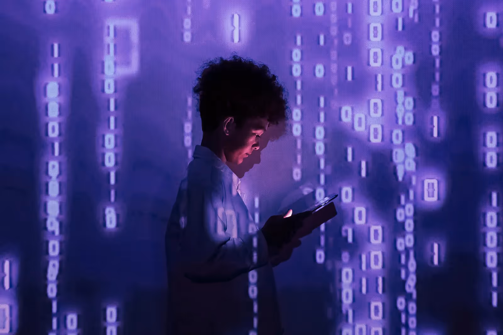 A boy scrolling through content on his phone screen with a lightning-filled background behind him