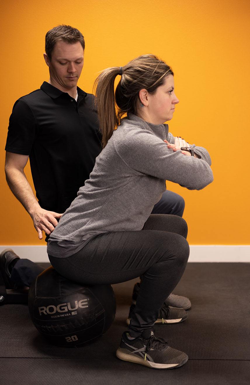 Active adult performing corrective exercises during physical therapy session in Mandan, ND