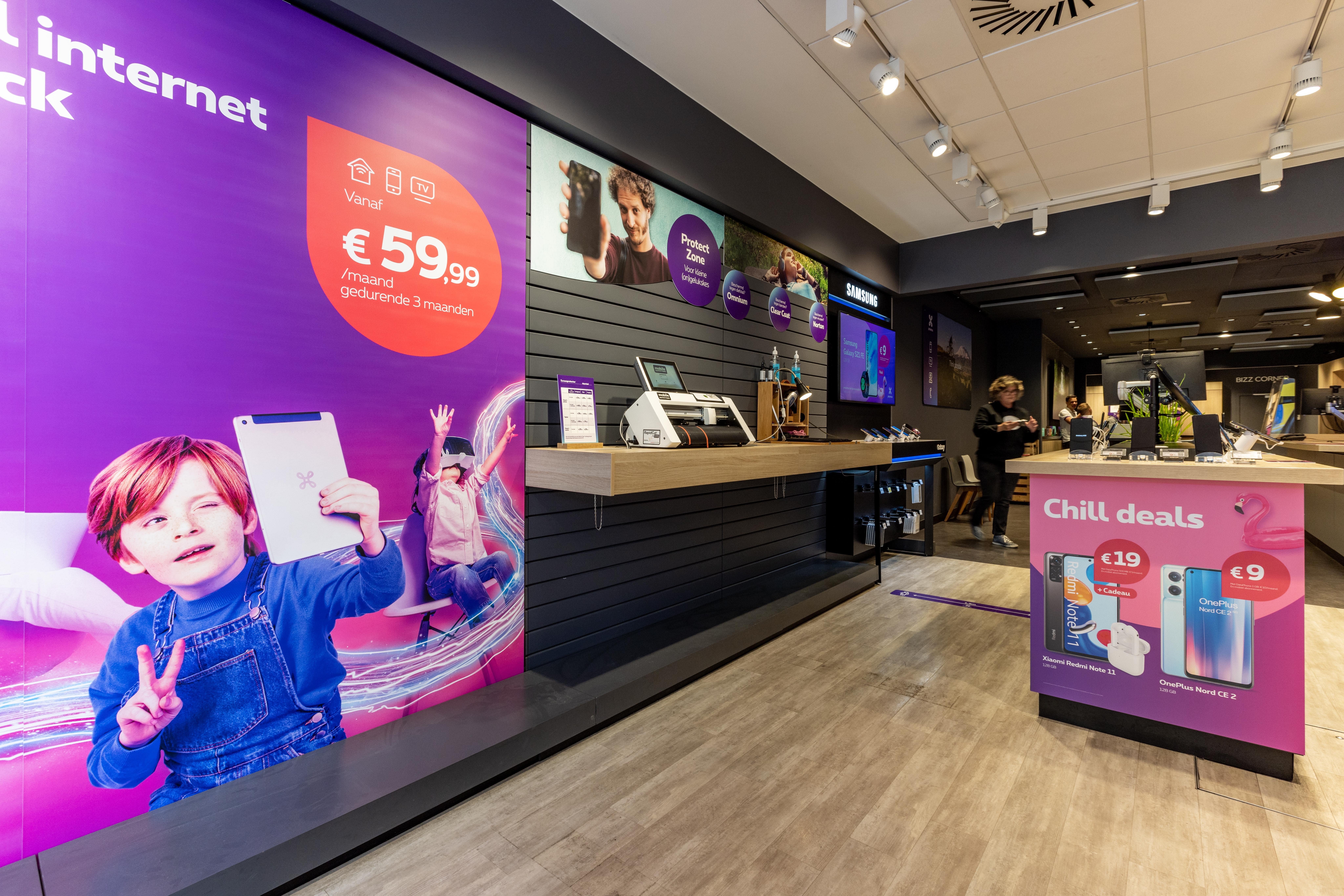 Proximus store interior with instore internet promotion signage, product displays, and checkout counter