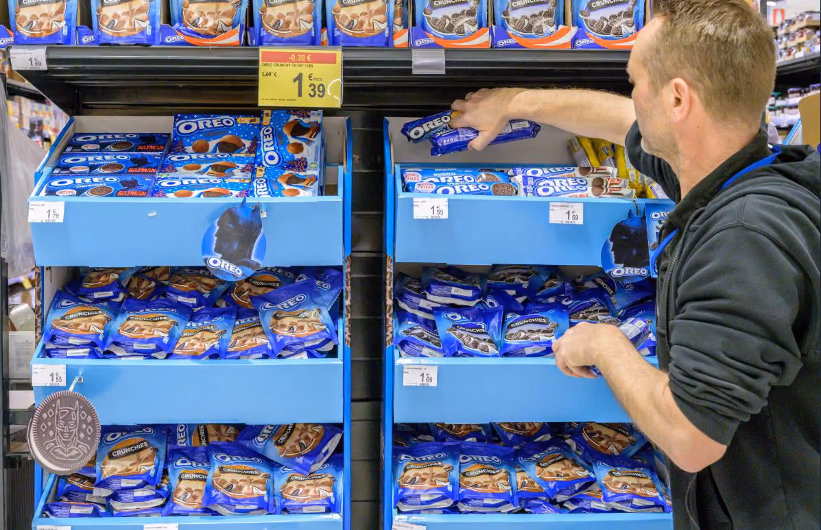 Field & Concept merchandiser restocking Oreo products on a supermarket shelf for Mondelez