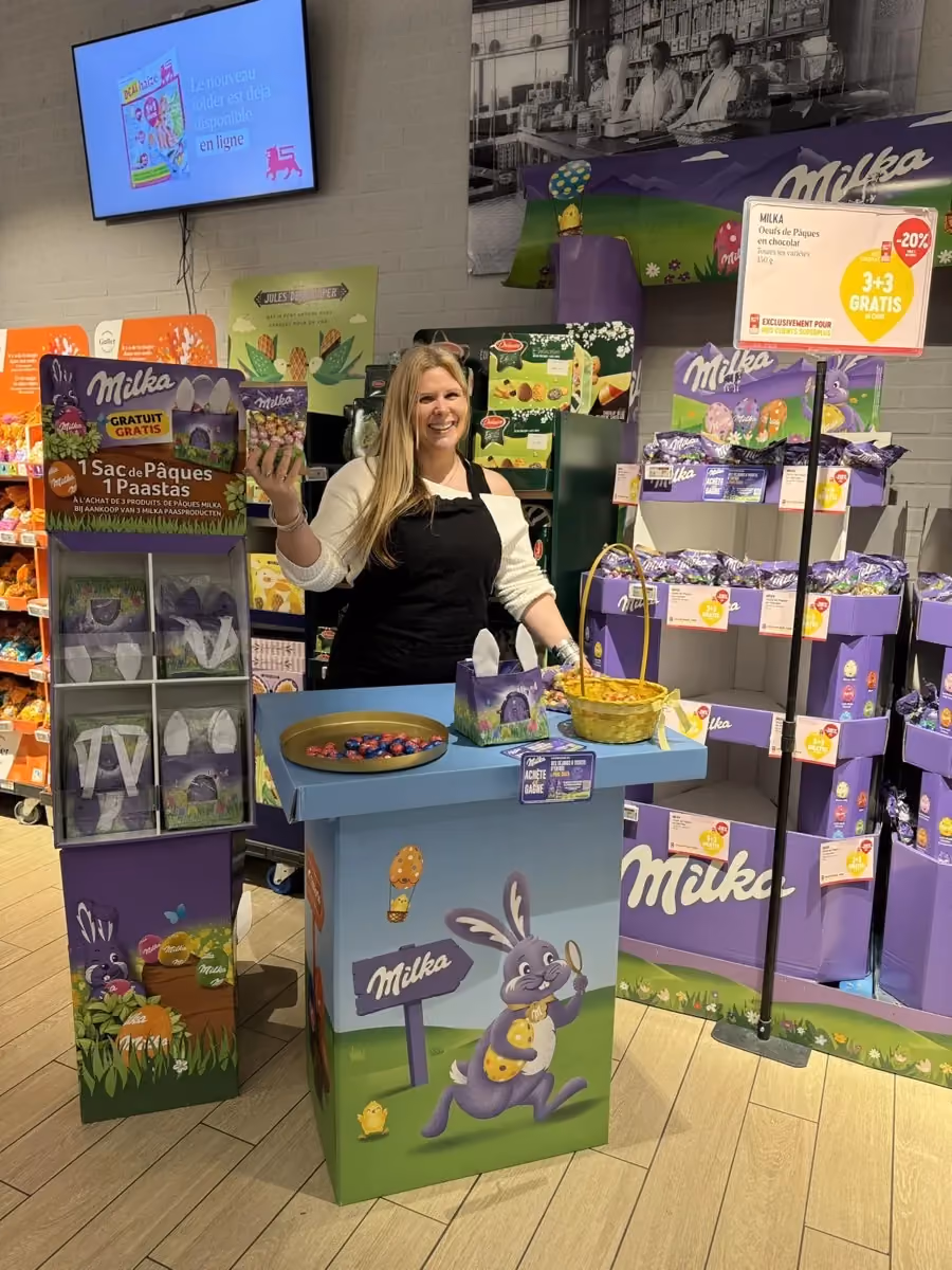 Field & Concept brand ambassador at a Milka Easter promotional stand with chocolate bunny displays