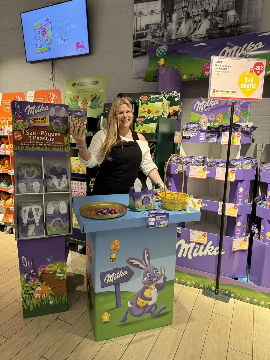 Field & Concept brand ambassador at a Milka Easter promotional stand with chocolate bunny displays