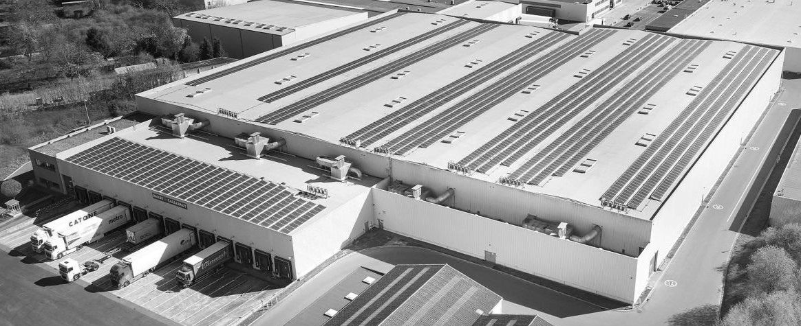 Aerial view of Field & Concept's warehouse facility with solar panel roofing and loading docks for retail and event logistics
