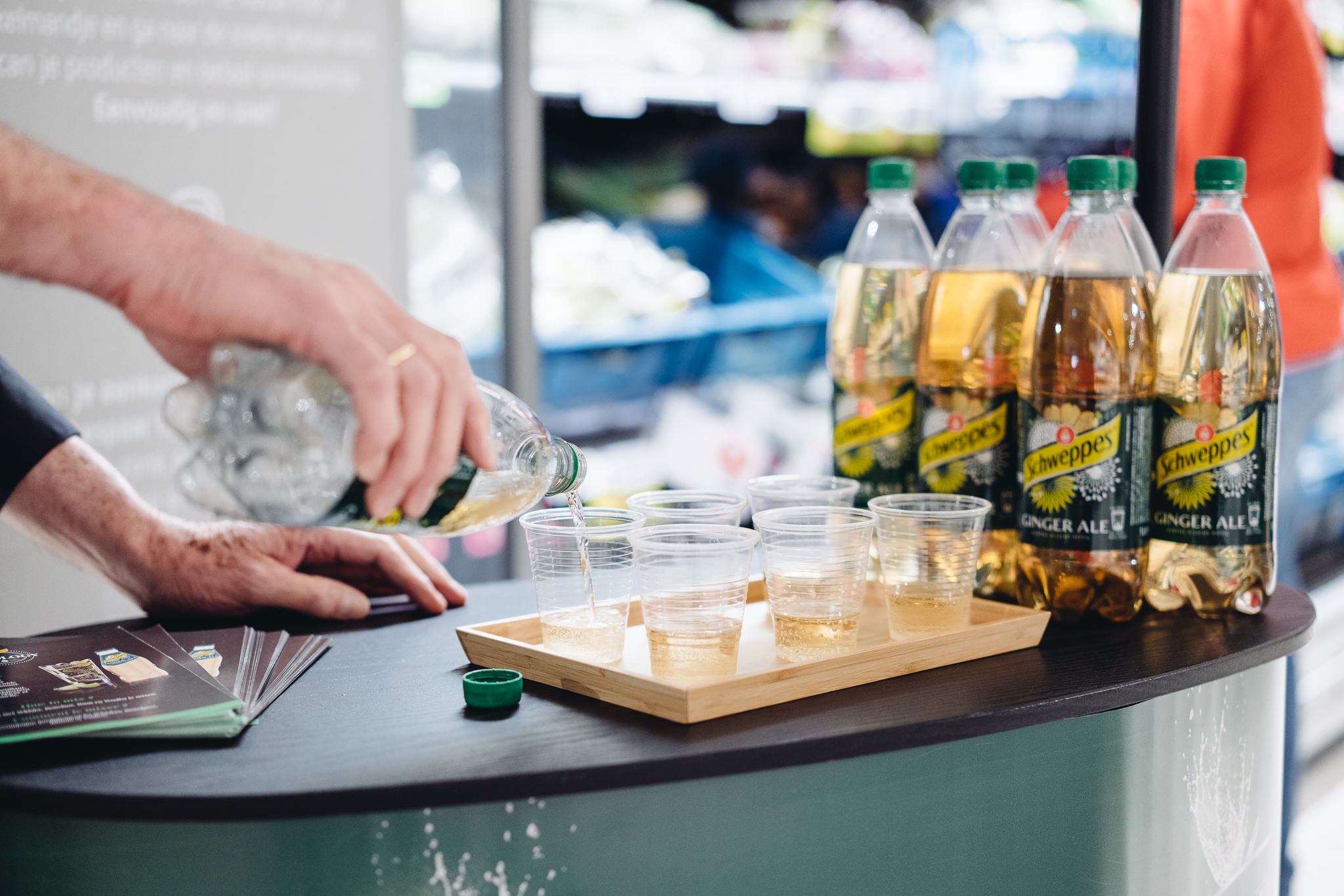 Field & Concept brand ambassador pouring Schweppes Ginger Ale samples into cups for an in-store tasting activation
