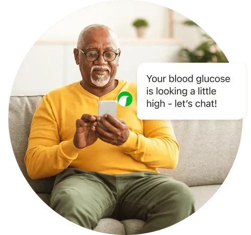 Older man looking at phone on couch