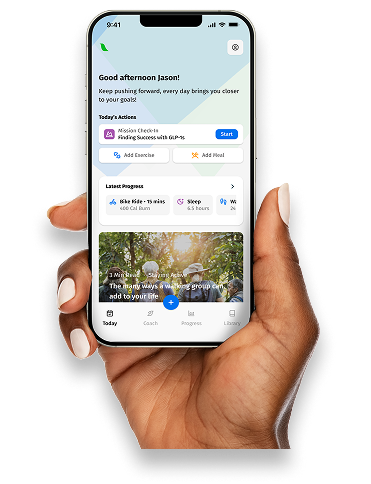 Hand holding smartphone displaying a fitness app with progress, actions, and motivational text.