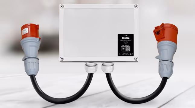An Xtellio Remote Power Kit Metering Switch box placed on a table in a bright environment