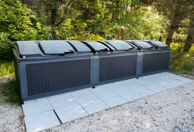A cluster of waste containers and multiple Xtellio Proxi Radar devices in front.