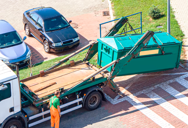 A worker oerating a truck lifting a  container, and an Xtellio Radar Xentral in front.