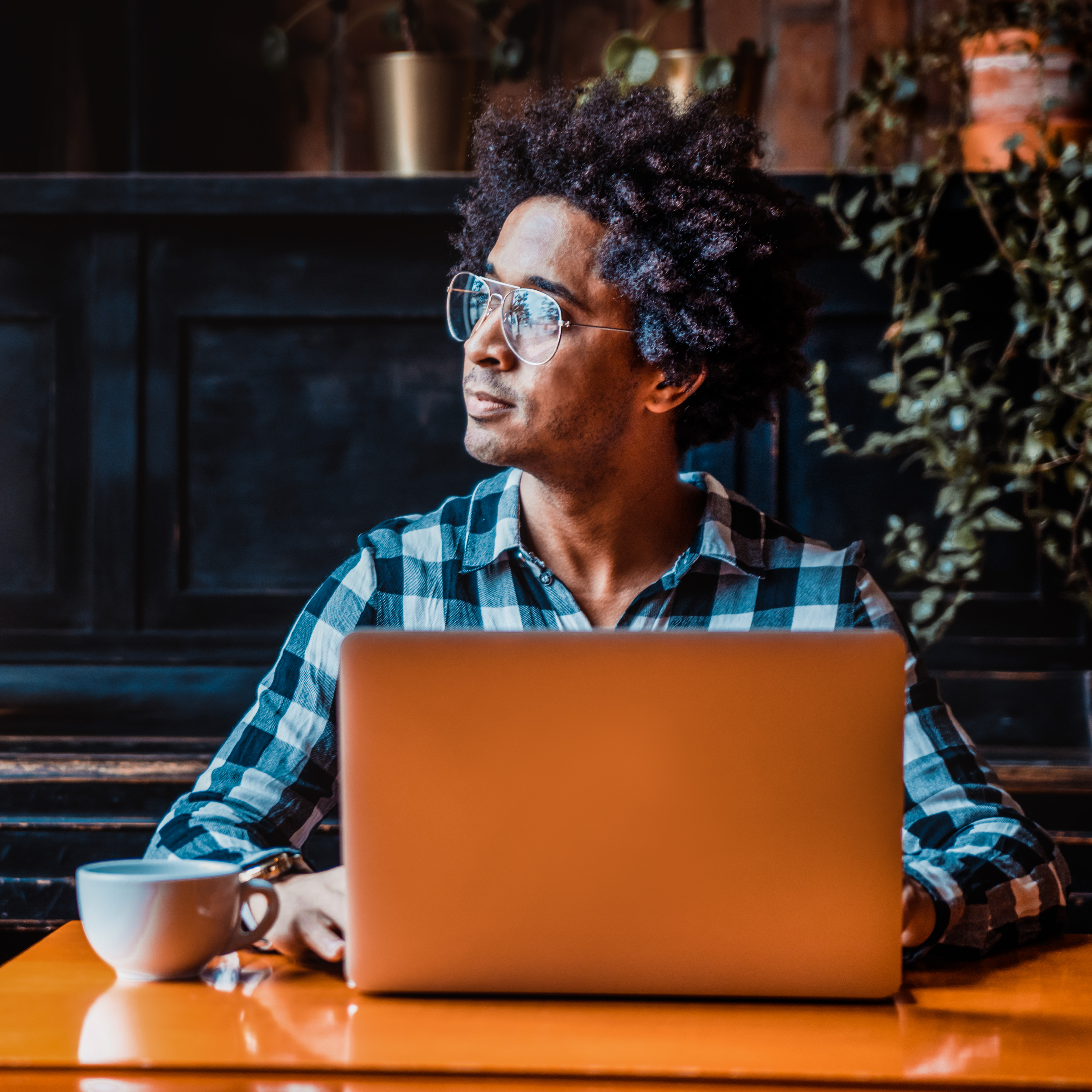 A man sitting and working in a coffee shop