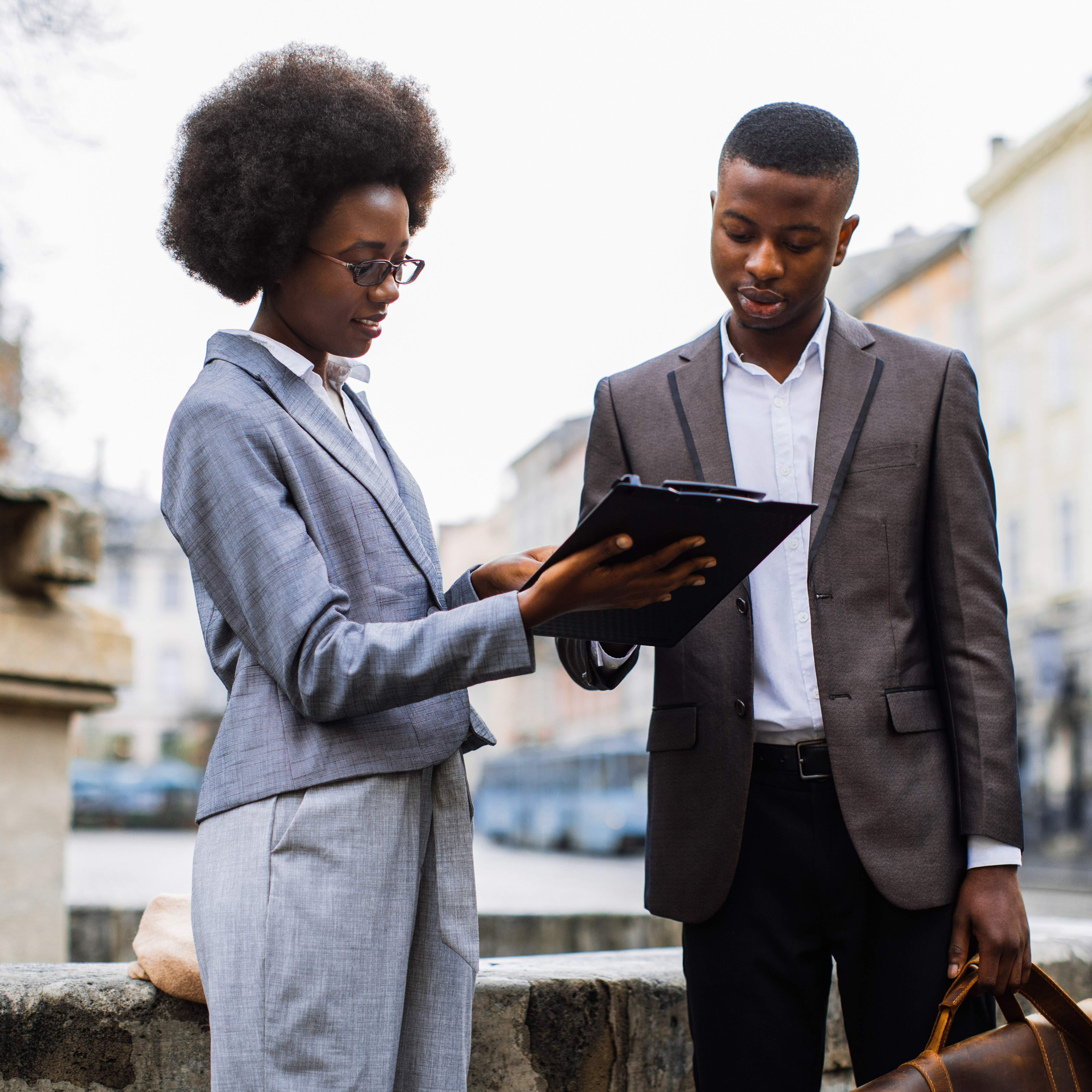 A woman and showing a client some content on a tablet
