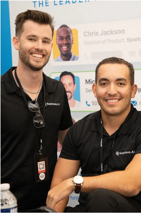 2 Seamless.AI employees working at an event.
