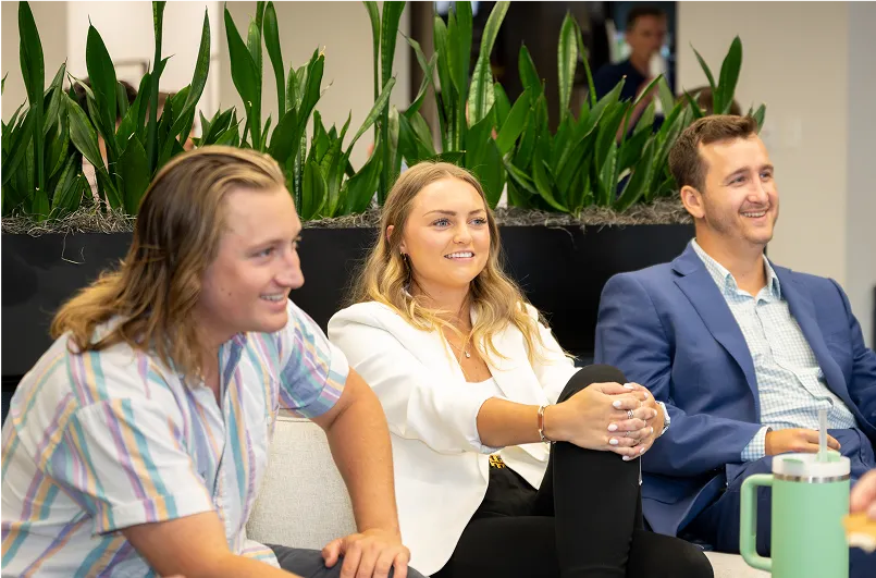Candid photo of 3 Seamless.AI employees sitting together.