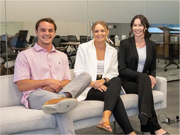 Group of employees sitting at a couch.