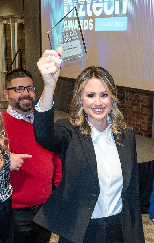 Photo of Danielle Demming, COO, accepting an award that Seamless had just won.