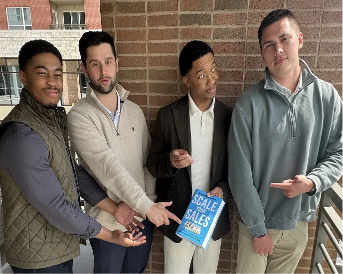 Four men holding up and pointing to Scale Your Sales by Brandon Bornancin.