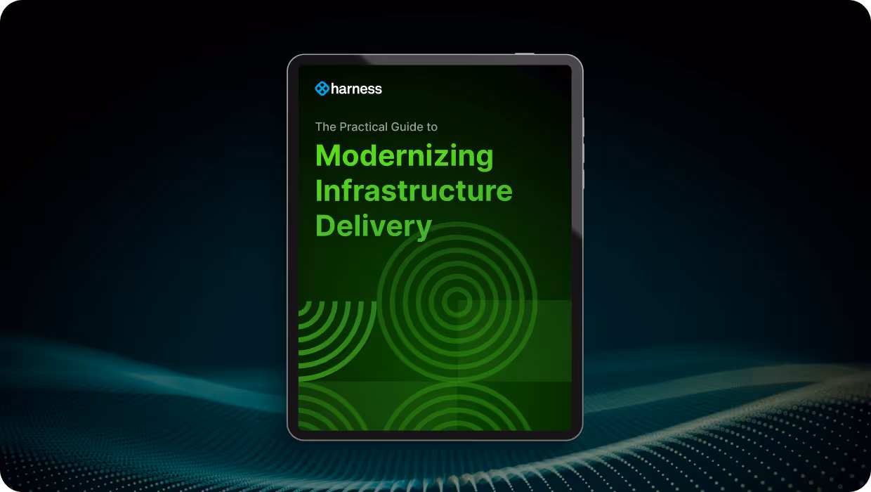 Tablet displaying the cover of a guide titled 'The Practical Guide to Modernizing Infrastructure Delivery' by Harness.