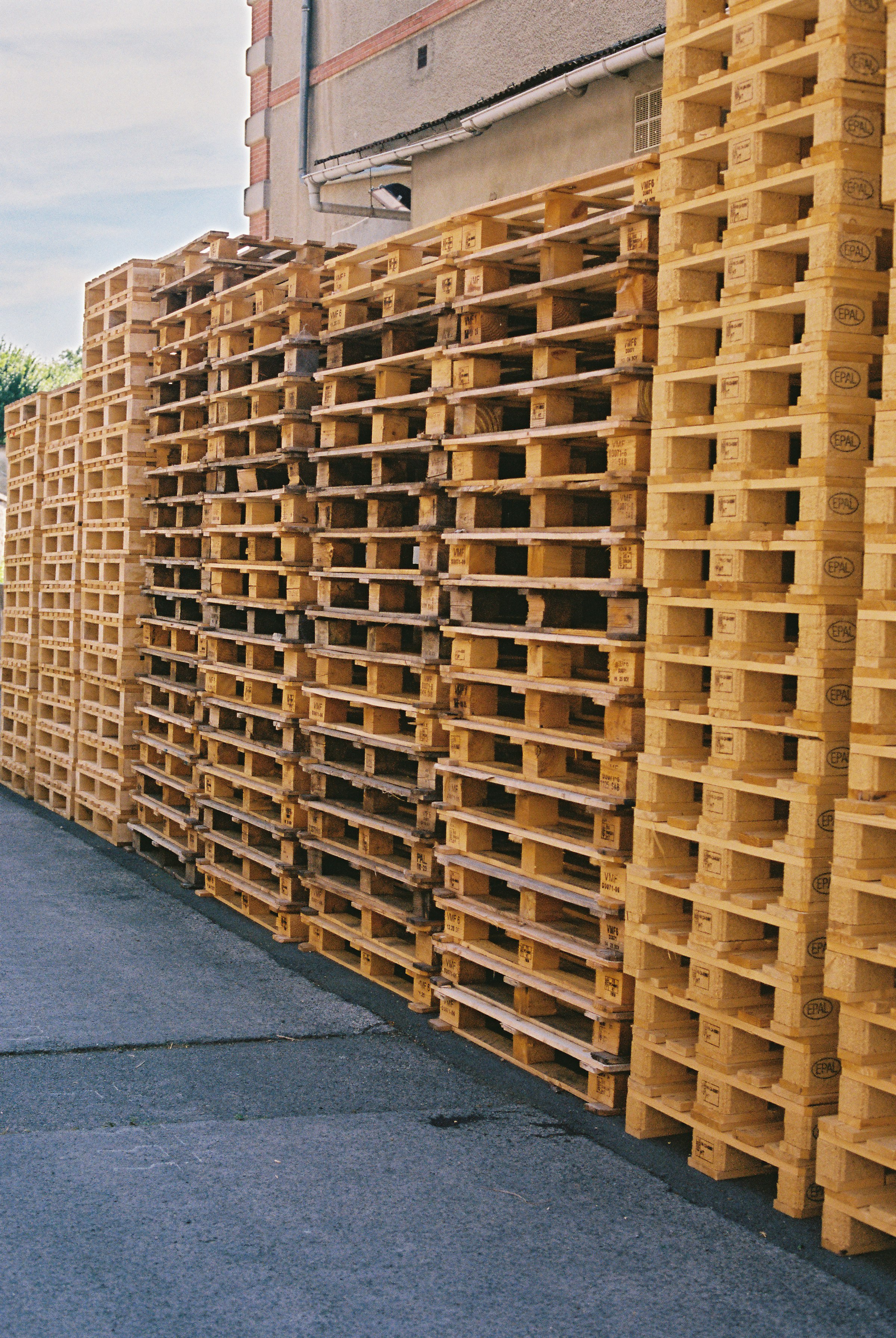 Warehouse exterior, pallets stacked outside