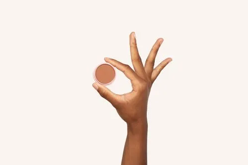 a hand model holding make up