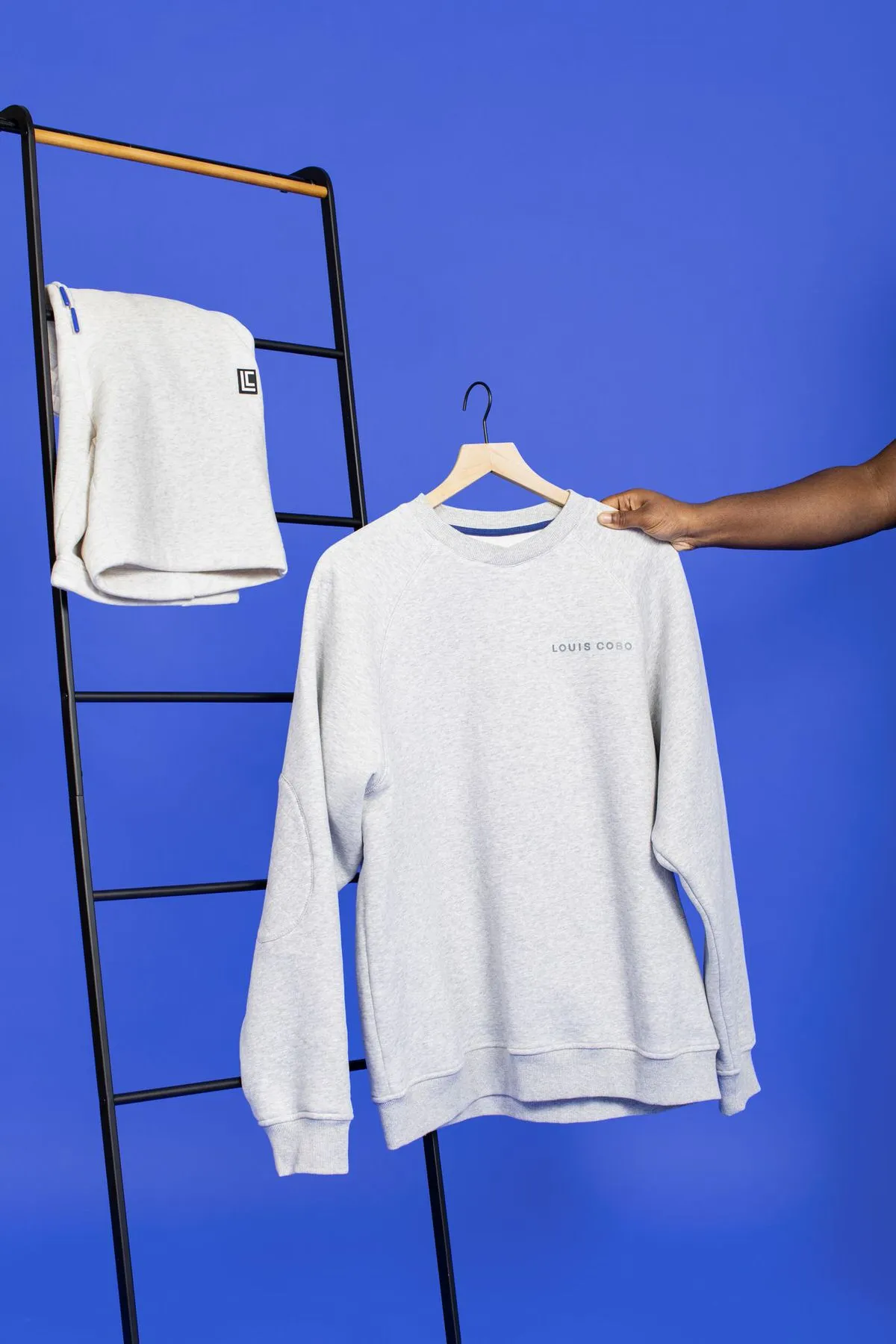 a sweatshirt on a blue backdrop