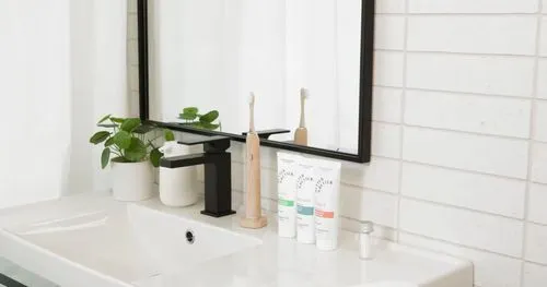 A bathroom vanity scene with toothbrushes and skincare products, styled in a clean, modern setting.