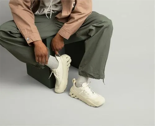 Model wearing white Crocs sneakers in lifestyle close-up
