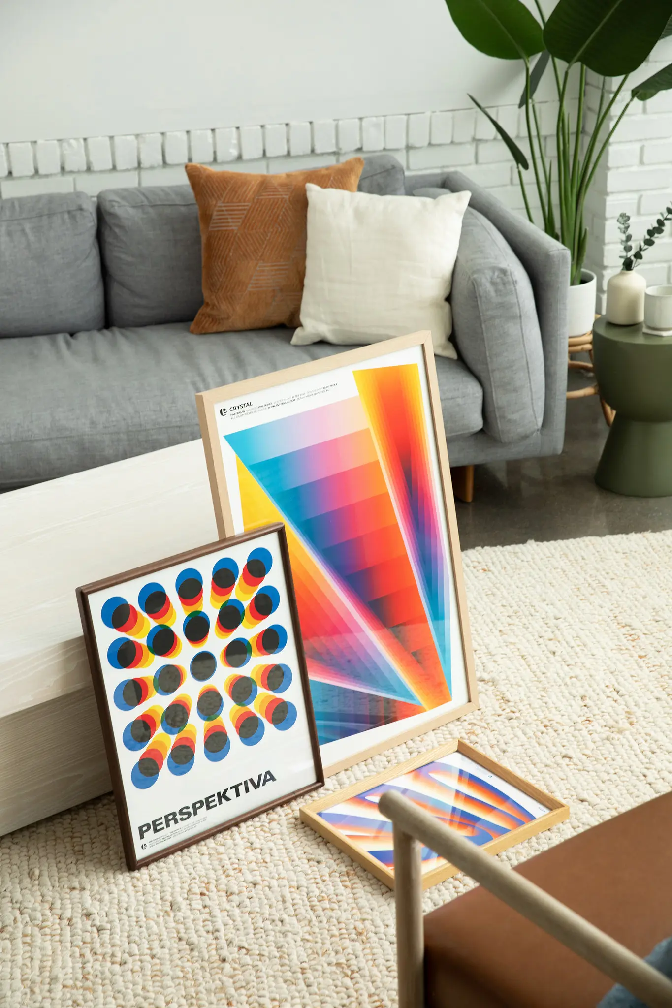 two graphic posters on the floor of a living room